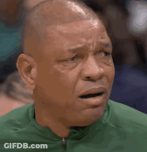 A Bald Man Wearing A Green Shirt Is Making A Surprised Face GIF