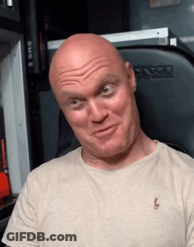 A Bald Man Wearing A Polo Shirt Makes A Face GIF