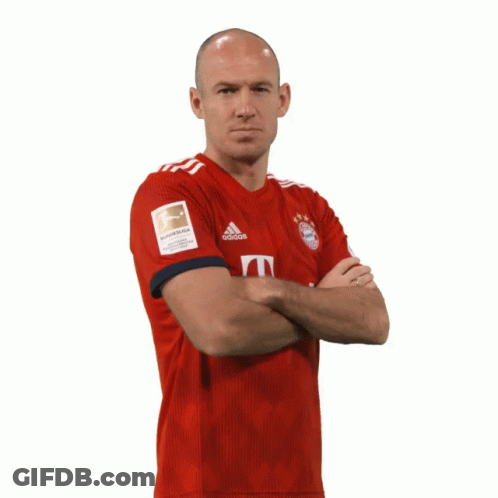 A Bald Man Wearing A Red Adidas Jersey Stands With His Arms Crossed GIF