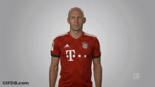 A Bald Man Wearing A Red Adidas Shirt With The Letter T On It GIF