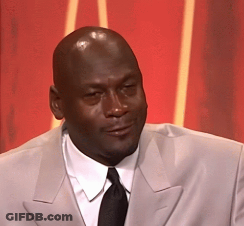 A Bald Man Wearing A Suit And Tie Looks To The Side GIF