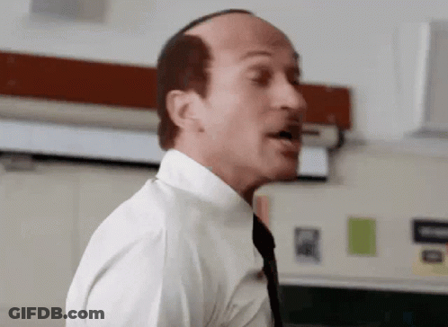 A Bald Man Wearing A White Shirt And Tie Is Talking GIF