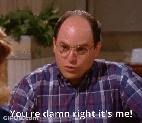 A Bald Man Wearing Glasses And A Plaid Shirt Is Talking To A Woman . GIF