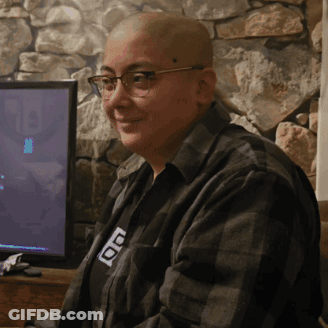 A Bald Man Wearing Glasses And A Shirt That Says ' Ao ' On It GIF