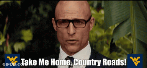 A Bald Man Wearing Glasses And A Suit Says Take Me Home Country Roads GIF