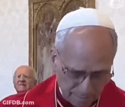 A Bald Man Wearing Glasses And A White Hat Looks Down GIF