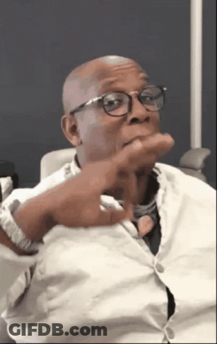 A Bald Man Wearing Glasses And A White Shirt GIF