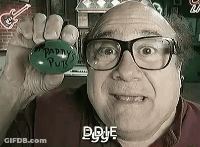A Bald Man Wearing Glasses Is Holding A Green Ball In His Hand In A Bar . GIF
