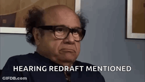 A Bald Man Wearing Glasses Is Sitting In Front Of A Wall And Says `` Hearing Redraft Mentioned '' . GIF