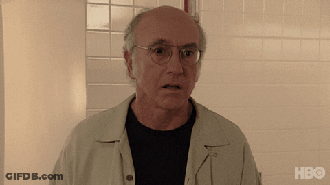 A Bald Man Wearing Glasses Stands In Front Of A White Tiled Wall With The Hbo Logo On The Bottom GIF