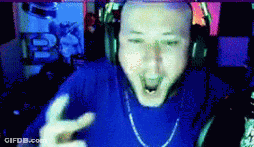 A Bald Man Wearing Headphones And A Blue Shirt Is Making A Peace Sign GIF