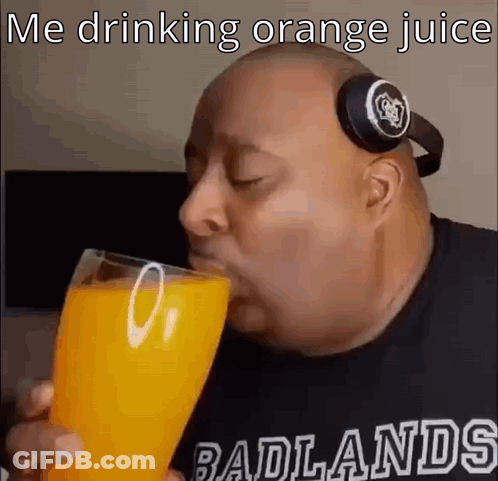 A Bald Man Wearing Headphones Is Drinking Orange Juice . GIF