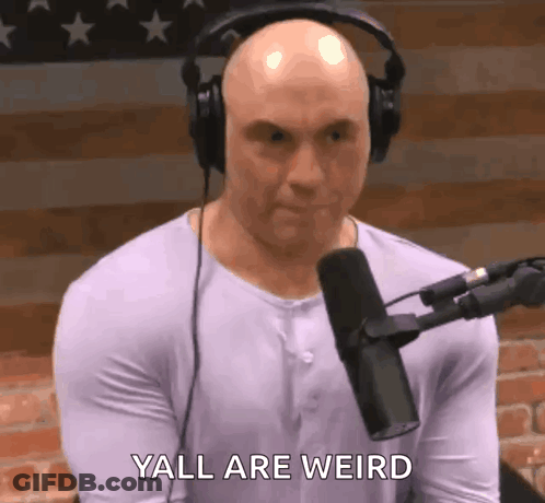 A Bald Man Wearing Headphones Is Talking Into A Microphone . GIF
