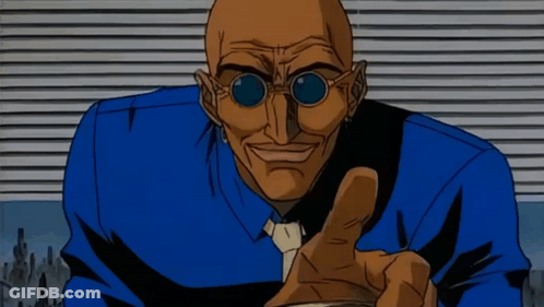 A Bald Man Wearing Sunglasses And A Blue Shirt Is Pointing His Finger GIF