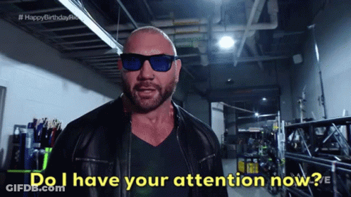 A Bald Man Wearing Sunglasses And A Leather Jacket Says " Do I Have Your Attention Now " GIF