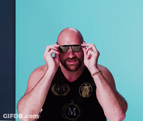 A Bald Man Wearing Sunglasses Has A Shirt That Says Gypsy King On It GIF