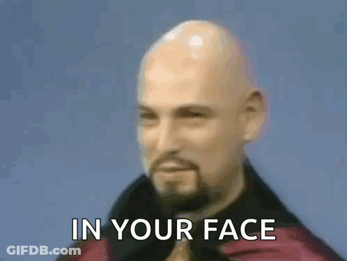 A Bald Man With A Beard And A Ring On His Finger Is Making A Devil Horns Sign With His Hands . GIF