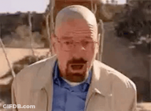 A Bald Man With A Beard And Glasses Is Making A Funny Face . GIF