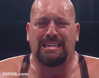 A Bald Man With A Beard Is Crying With His Eyes Closed In A Boxing Ring . GIF