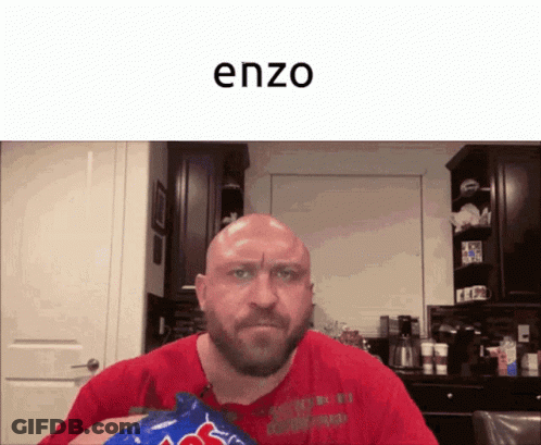 A Bald Man With A Beard Is Holding A Bag Of M & Ms GIF