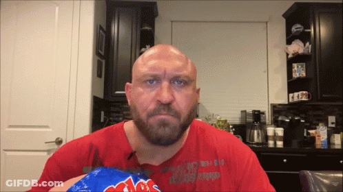 A Bald Man With A Beard Is Holding A Bag Of Mrs. Potato Chips In His Hand GIF