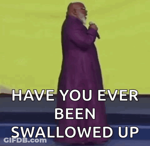 A Bald Man With A Beard Is Holding A Microphone And Says `` Have You Ever Been Swallowed Up '' . GIF