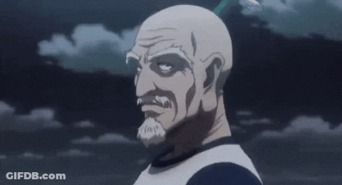 A Bald Man With A Beard Is Holding His Hand To His Chin And Looking At The Camera . GIF