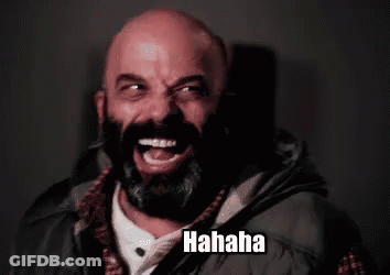 A Bald Man With A Beard Is Laughing While Wearing A Vest . GIF