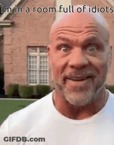A Bald Man With A Beard Is Making A Funny Face In Front Of A House . GIF