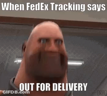 A Bald Man With A Beard Is Making A Funny Face While Standing In A Room . GIF
