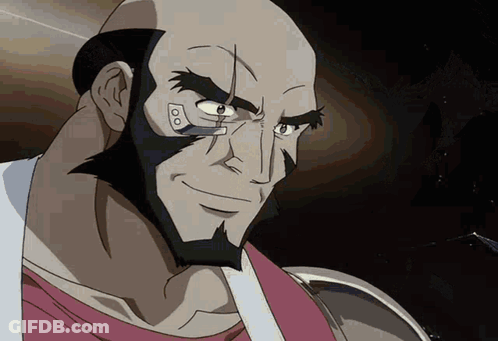 A Bald Man With A Beard Is Smiling And Looking At Something GIF