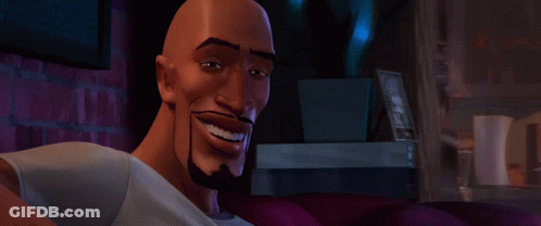 A Bald Man With A Beard Is Smiling And Looking At The Camera GIF