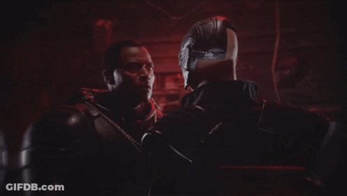 A Bald Man With A Beard Is Smiling In Front Of Another Bald Man GIF