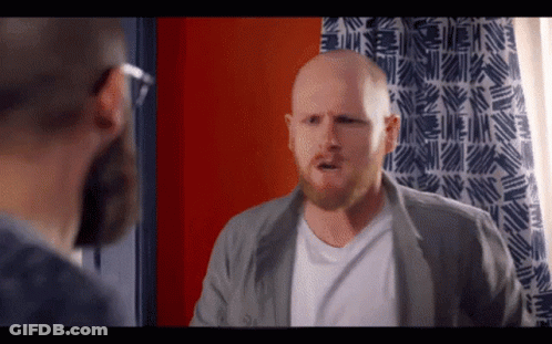 Bald Man With Beard In Front Of Blue White Curtain GIF