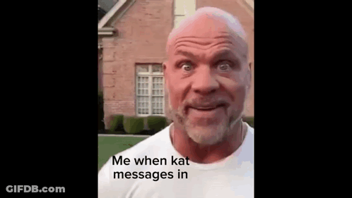 A Bald Man With A Beard Is Standing In Front Of A Brick House And Making A Funny Face . GIF