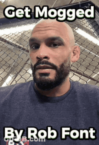 A Bald Man With A Beard Is Standing In Front Of A Chain Link Fence With The Caption Get Mogged By Rob Font GIF