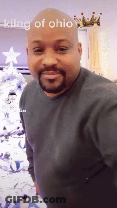 A Bald Man With A Beard Is Standing In Front Of A Christmas Tree With The Words King Of Ohio Above Him GIF