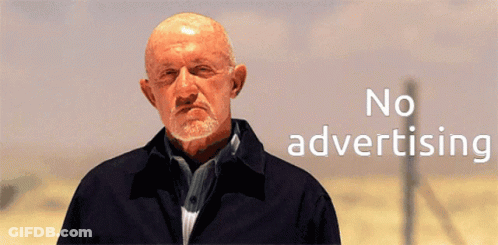 A Bald Man With A Beard Is Standing In Front Of A Sign That Says No Advertising GIF