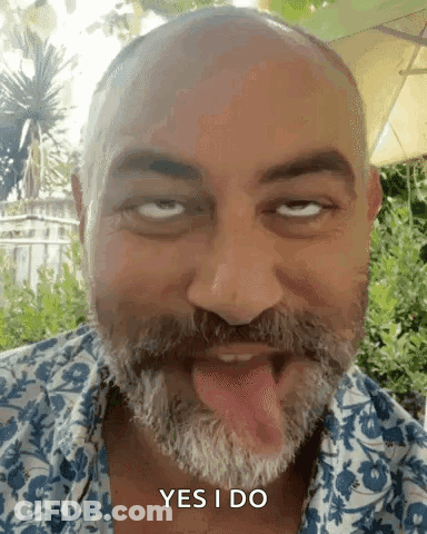 A Bald Man With A Beard Is Sticking His Tongue Out And Saying Yes I Do . GIF