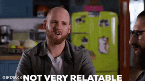 Bald Man With Beard Talking To Another In Kitchen GIF