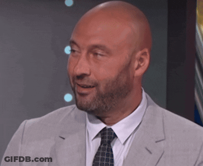 A Bald Man With A Beard Is Wearing A Grey Suit And Tie GIF