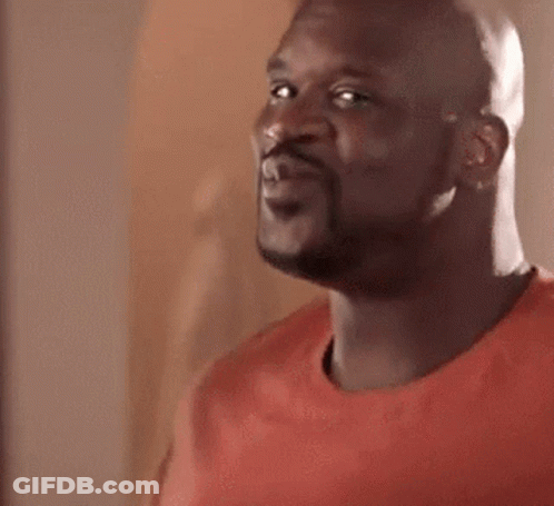A Bald Man With A Beard Is Wearing A Red Shirt . GIF
