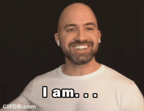 A Bald Man With A Beard Is Wearing A White Shirt That Says " I Am " On It GIF