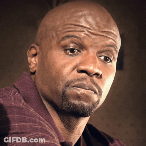 A Bald Man With A Beard Looks At The Camera With A Serious Look On His Face GIF