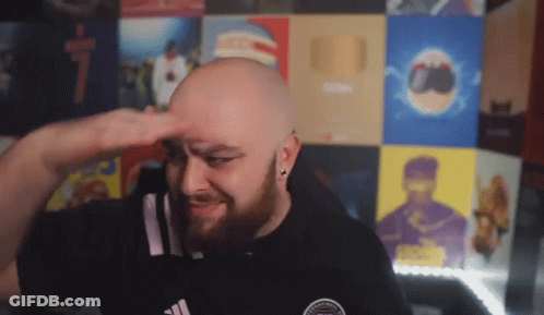 A Bald Man With A Beard Wearing A Black Adidas Shirt Salutes GIF