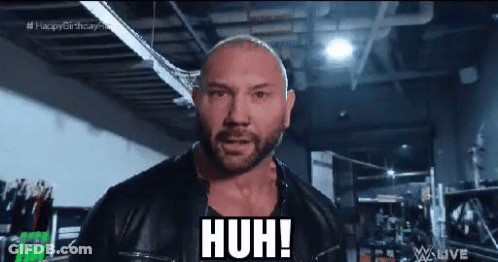 A Bald Man With A Beard Wearing A Black Leather Jacket Is Making A Funny Face . GIF