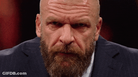 A Bald Man With A Beard Wearing A Blue Suit GIF