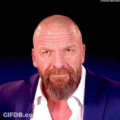 A Bald Man With A Beard Wearing A Blue Suit GIF