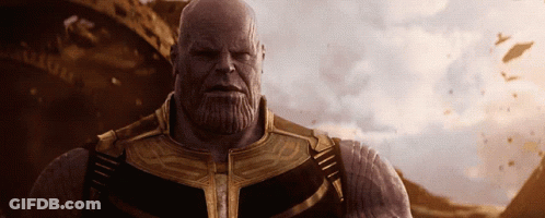 A Bald Man With A Beard Wearing A Gold And Black Suit GIF