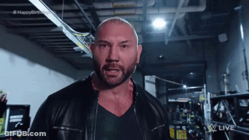 A Bald Man With A Beard Wearing A Leather Jacket GIF